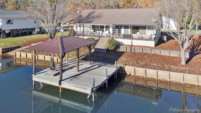 dock area featuring a gazebo, a water view, and a patio