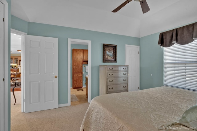 bedroom with ceiling fan, light carpet, and vaulted ceiling