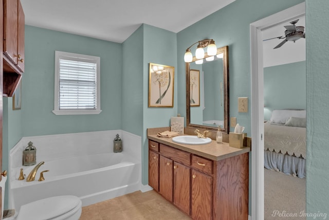 bathroom featuring a tub to relax in, ceiling fan, vanity, and toilet