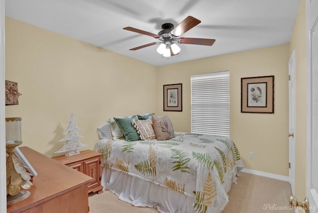 bedroom with ceiling fan and light colored carpet