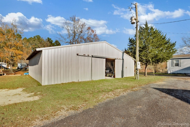view of outdoor structure featuring a lawn