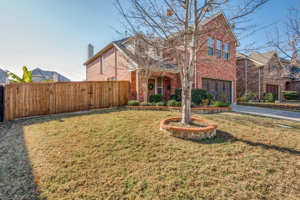 view of front of property with a garage and a front lawn