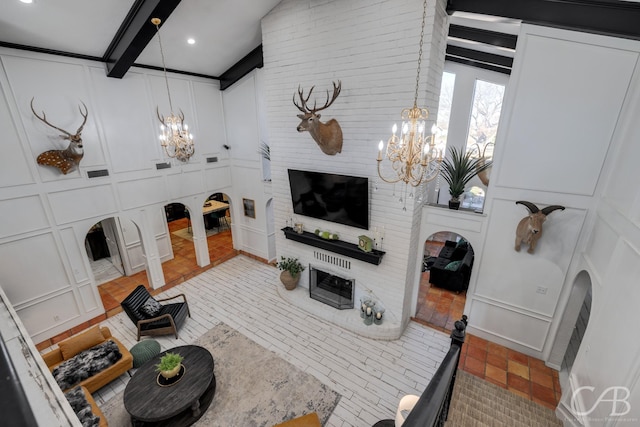 living room featuring an inviting chandelier and beam ceiling