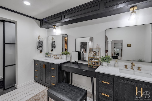 bathroom with ornamental molding and vanity