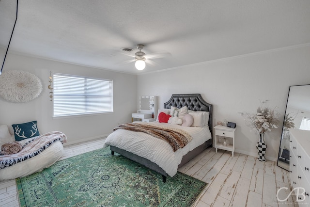 bedroom featuring ceiling fan, ornamental molding, and light hardwood / wood-style floors