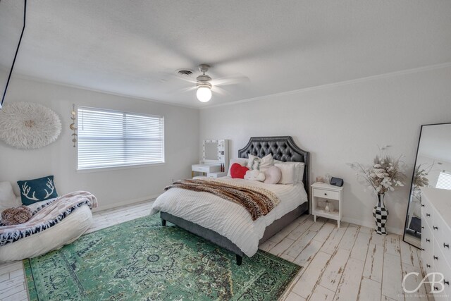 bedroom featuring ceiling fan, ornamental molding, and light wood-type flooring