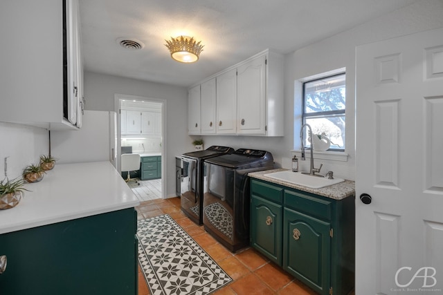 laundry area featuring sink, cabinets, washing machine and clothes dryer, and light tile patterned flooring