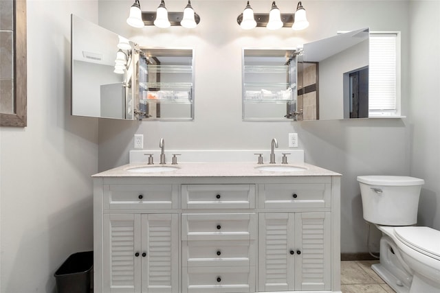 bathroom featuring tile patterned flooring, vanity, and toilet