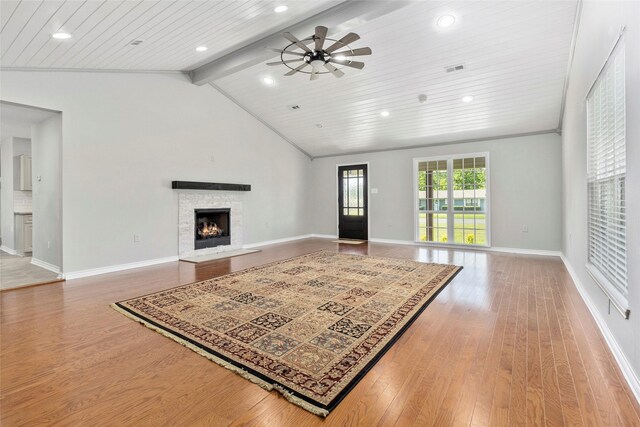 living room with hardwood / wood-style floors, a fireplace, lofted ceiling with beams, and ceiling fan