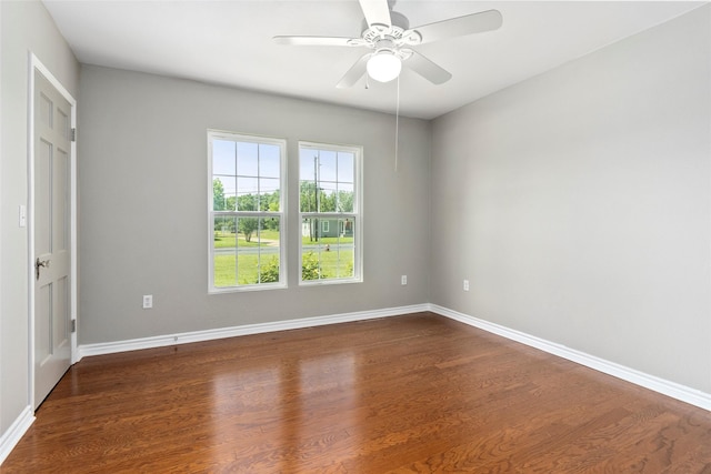 spare room featuring ceiling fan and dark wood-type flooring