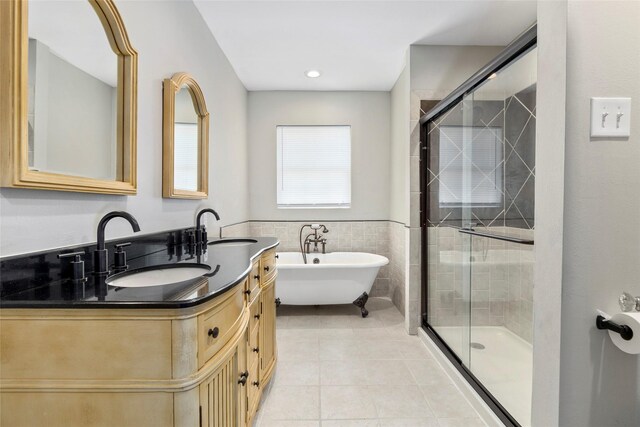 bathroom featuring tile patterned flooring, vanity, separate shower and tub, and tile walls