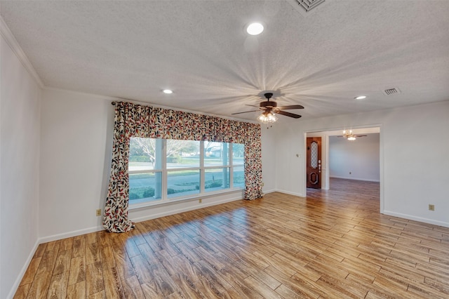 spare room with light hardwood / wood-style flooring and a textured ceiling