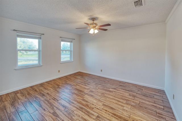 spare room with crown molding, ceiling fan, light hardwood / wood-style floors, and a textured ceiling