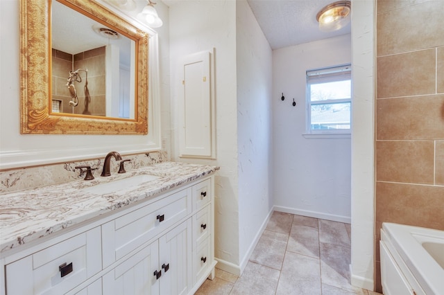 bathroom with tile patterned floors, separate shower and tub, vanity, and a textured ceiling