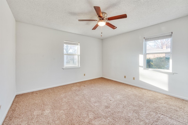 unfurnished room featuring carpet flooring, a textured ceiling, and ceiling fan