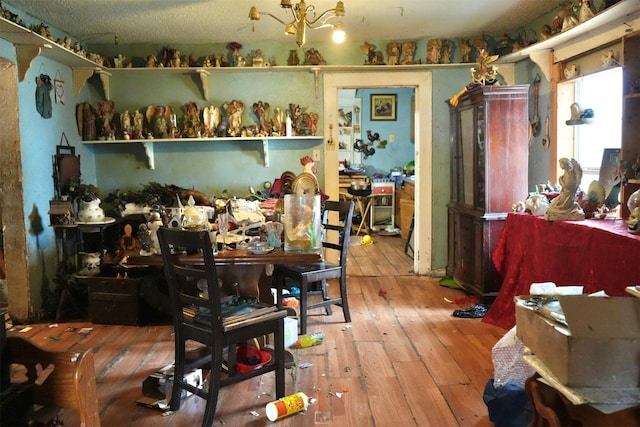 miscellaneous room with hardwood / wood-style floors and a chandelier