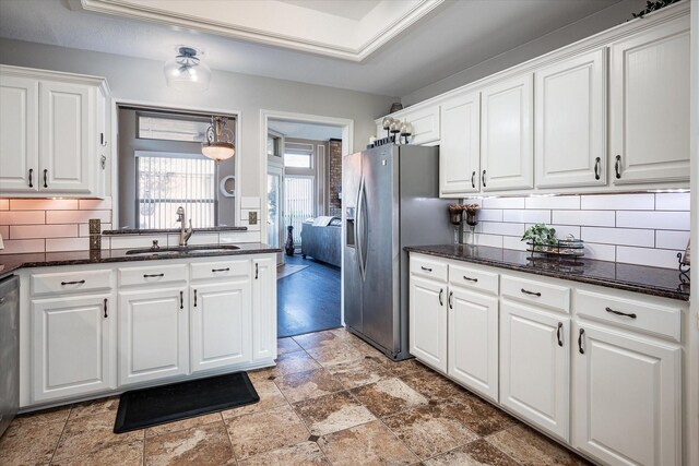 kitchen featuring decorative backsplash, sink, white cabinets, and stainless steel appliances