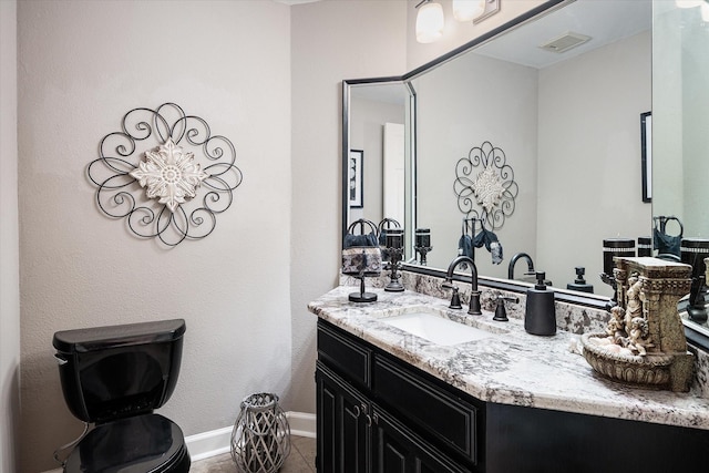 bathroom featuring tile patterned floors, vanity, and toilet