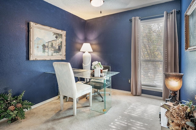 home office featuring carpet floors and a textured ceiling