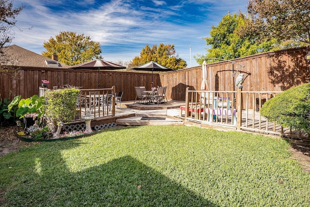 view of yard with a patio area and a wooden deck