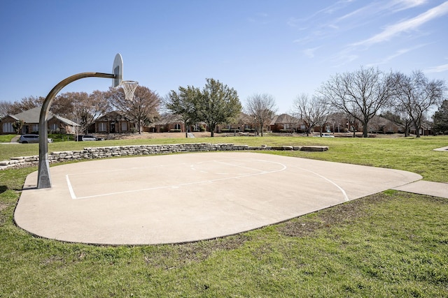 view of basketball court with a lawn