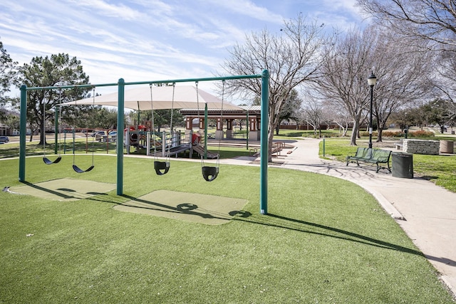 view of community featuring a playground and a yard