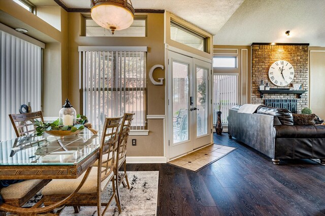 dining space featuring a wealth of natural light, french doors, dark wood-type flooring, and a textured ceiling