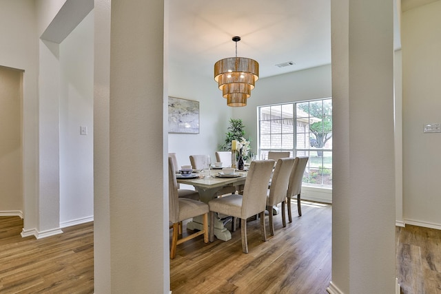 dining space with hardwood / wood-style floors