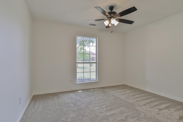 spare room with ceiling fan and light carpet