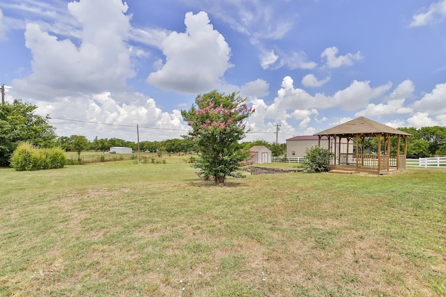 view of yard with a gazebo and a storage unit