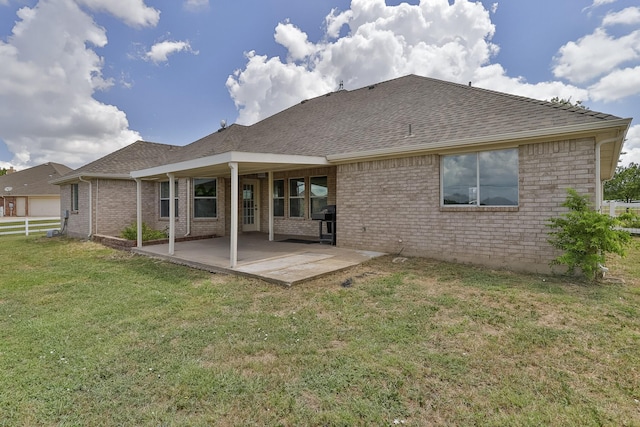 back of property featuring a patio area and a yard