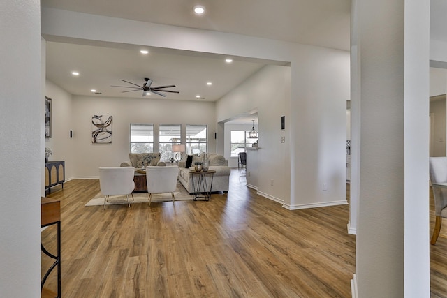 living room with ceiling fan and light hardwood / wood-style flooring