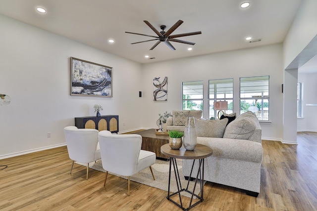 living room with hardwood / wood-style flooring and ceiling fan