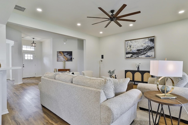 living room featuring ceiling fan and hardwood / wood-style floors