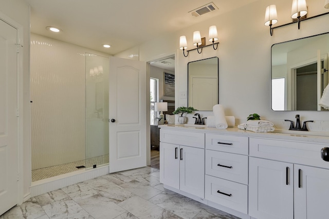 bathroom with vanity and tiled shower