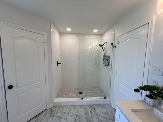 bathroom featuring vanity and a tile shower