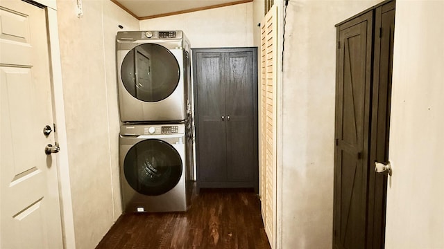 clothes washing area featuring laundry area, stacked washer and dryer, crown molding, and dark wood-style flooring