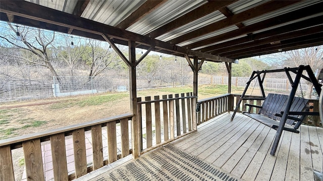 wooden terrace with a lawn and a fenced backyard