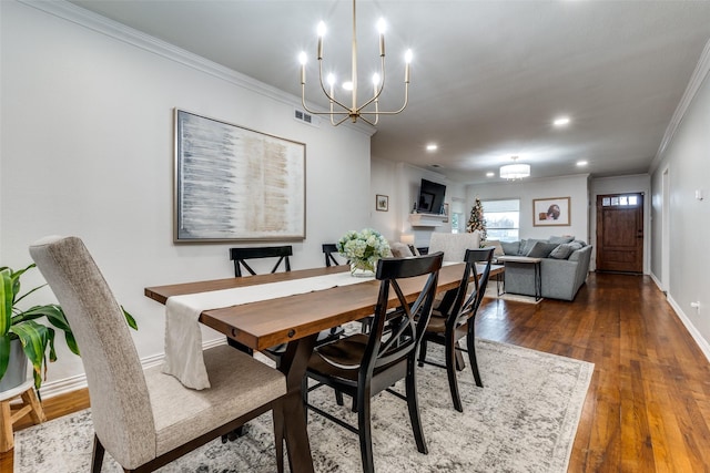 dining space featuring ornamental molding, a notable chandelier, and dark hardwood / wood-style flooring