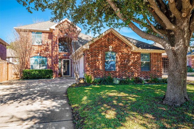 view of front of house featuring a garage and a front lawn