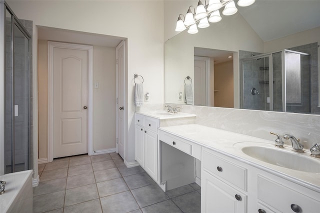 bathroom featuring tile patterned floors, vanity, a shower with door, and vaulted ceiling