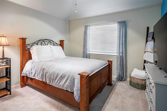 carpeted bedroom with lofted ceiling