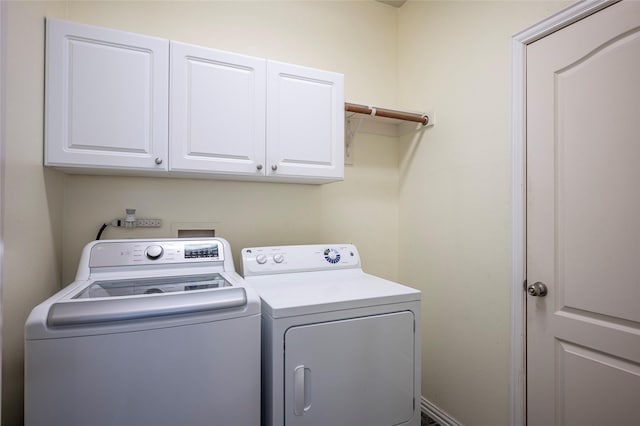 laundry room with cabinets and washer and dryer