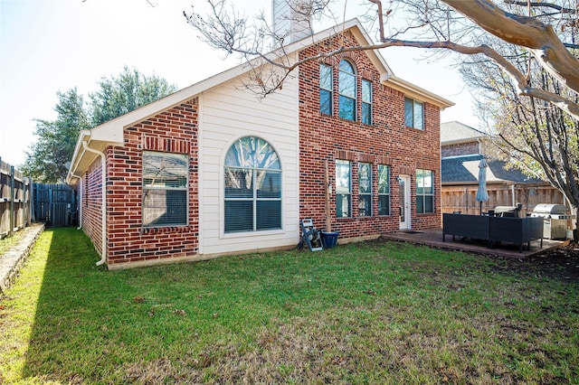 rear view of property with a patio area, a yard, and an outdoor hangout area