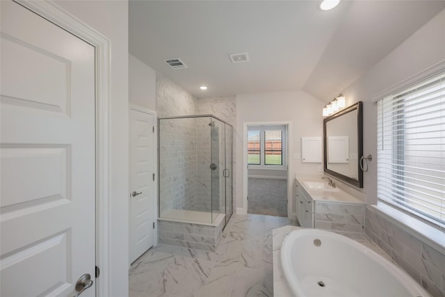 bathroom featuring vanity, vaulted ceiling, and independent shower and bath