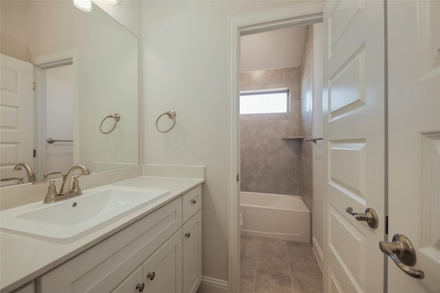 bathroom featuring vanity, tile patterned floors, and tiled shower / bath