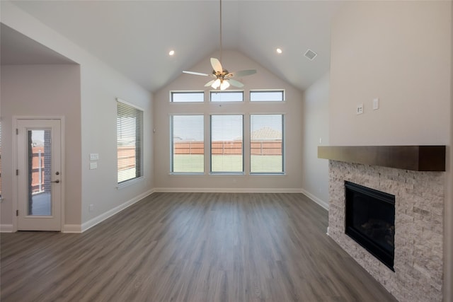 unfurnished living room featuring dark hardwood / wood-style flooring, a fireplace, ceiling fan, and plenty of natural light