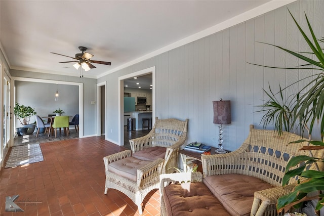 living room featuring ceiling fan and ornamental molding