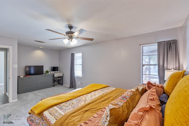 bedroom featuring ceiling fan and light carpet