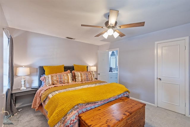 carpeted bedroom featuring ensuite bath and ceiling fan